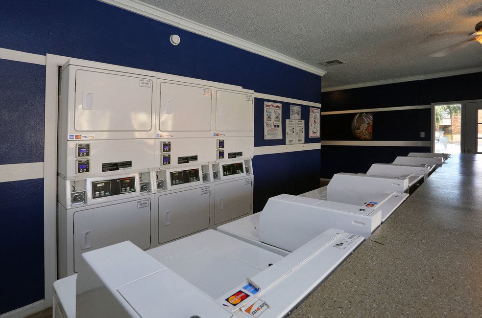 A laundromat with rows of washers and dryers.